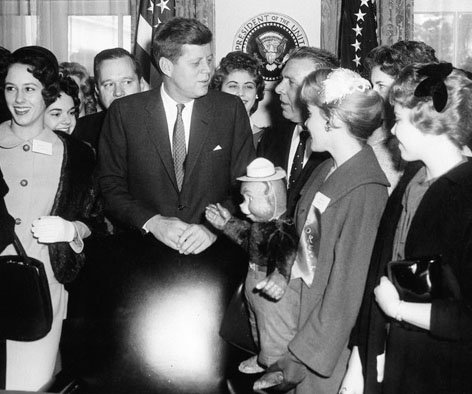 President John F. Kennedy meets with the U.S. National Forestry Queen, holding a Smokey Bear doll, in 1961.