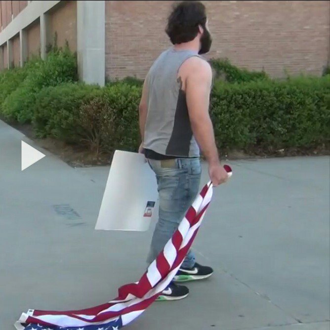 Picture: Tommy Dimassimo drags American flag on ground