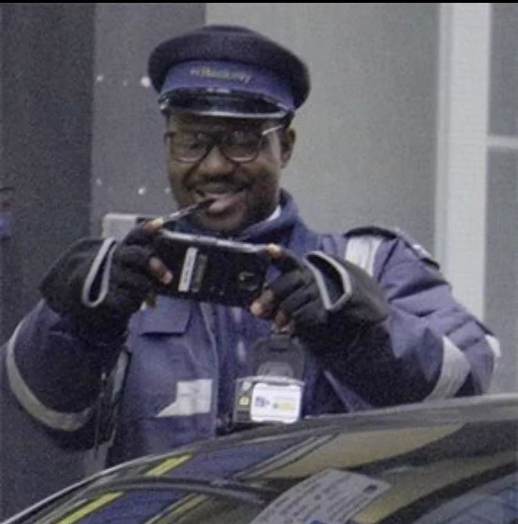 FanWithoutPlan's tweet image. Current mood: The man putting a parking ticket on Harry Style's car and taking a picture of it.