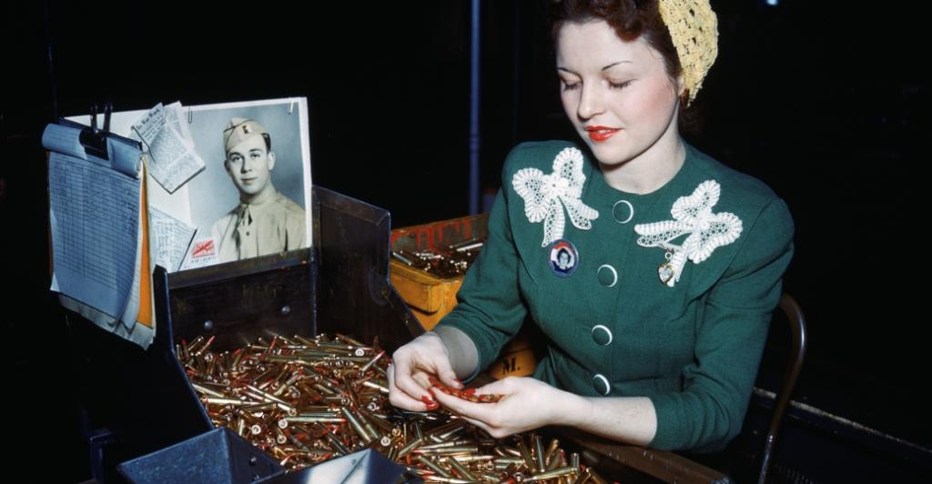 Fee Perez inspects bullets at Remington Arms Company's plant during WWII.
