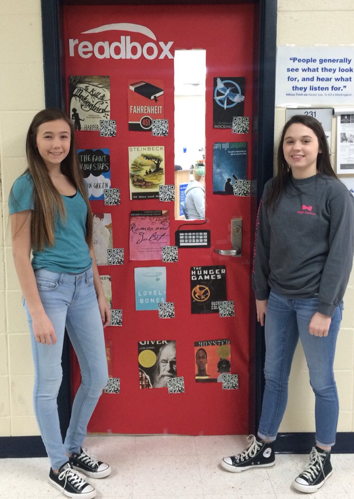 Lynne0211's tweet image. Best classroom door ever, complete with quality book titles and QR codes! @RachCarmack @peytonmartin0 
#Readbox ❤️📚