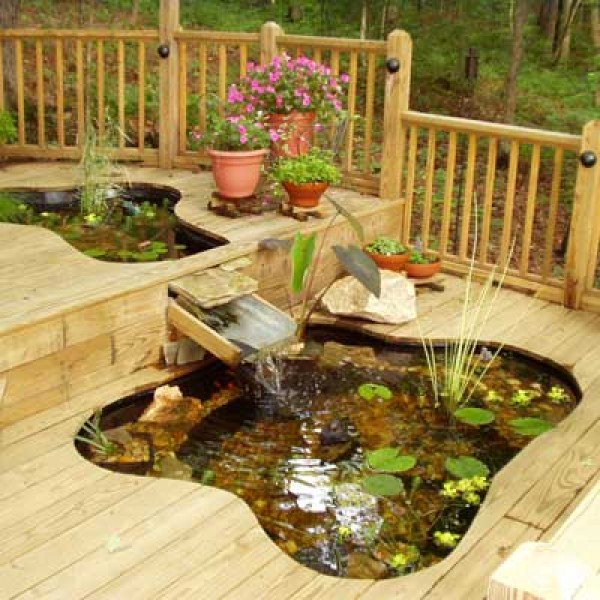 Ponds work just as well on decking as on lawns! We love the way this one makes use of the step to create a waterfall