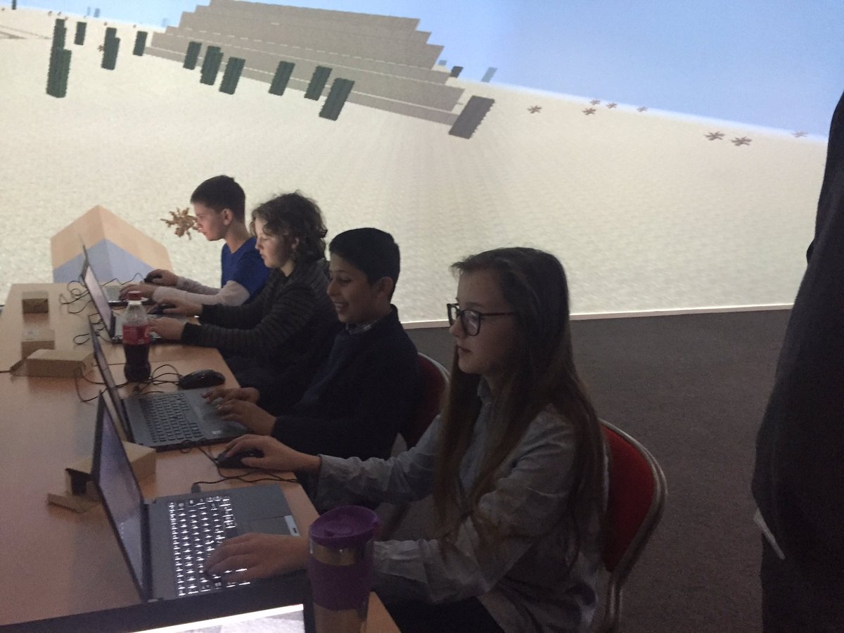KirstyGrundySTP's tweet photo. @innovativeteach hands out #Microbits @ our #Minecraft holiday hack event with Y7 in immersive room @microsofteduk https://t.co/GkC2WufH7D