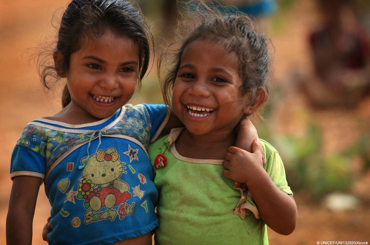 UNICEF's tweet photo. Happy #HappinessDay! Pictured, friends Ilaria and Juvalina smile in Timor-Leste. https://t.co/RTYu4xjZFI