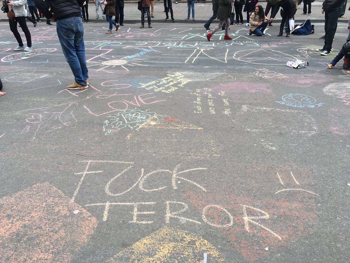 On Bourse square in #Brussels, people writing chalk messages of peace and resilience