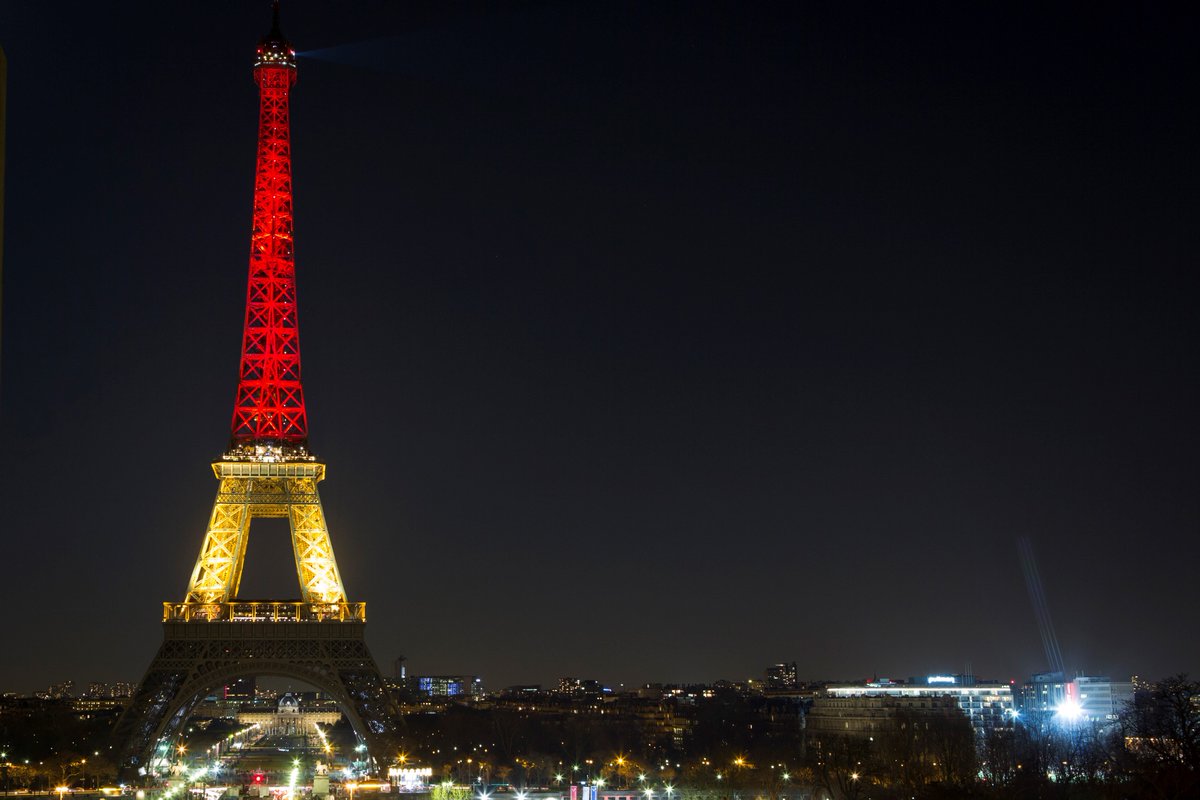HuffPost's tweet photo. The Eiffel Tower lit up with Belgium's flag colors following the #Brussels attacks. (Photo: Getty) https://t.co/9Rnae43j2F