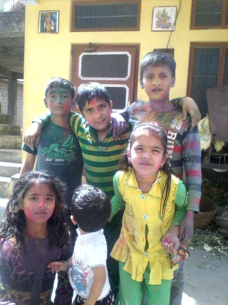 Village children enjoying holi.  ""Happy holi to all people """"