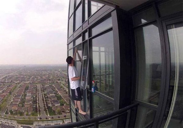 Casually stepping out to clean the windows. We highly recommend you do not copy this man! #healthandsafety