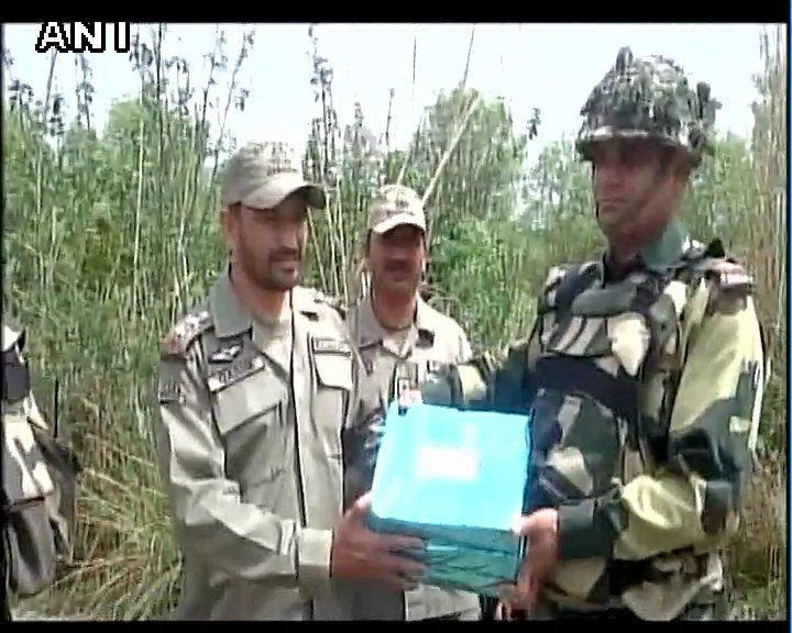 ANI's tweet image. Samba(J&amp;amp;K): BSF and Pakistan Rangers exchange sweets at the border #Holi