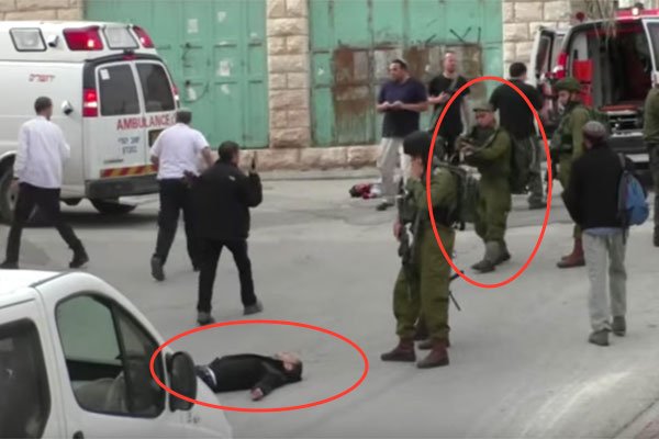 theIMEU's tweet image. GRAPHIC VIDEO: Israeli soldier executes unarmed, wounded Palestinian youth bit.ly/1q46iQz