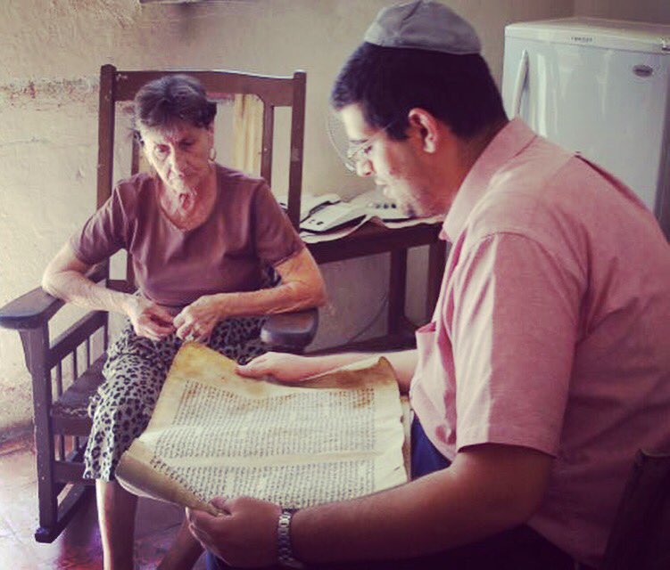 TheJDC's tweet photo. Chag sameach! Check out this 2006 photo of a volunteer reading the Megillah to an elderly Jew in old Havana. https://t.co/qVQeHMM0q6