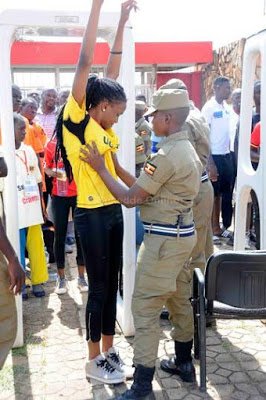 Security frisking women for dangerous devices before a match in Uganda ...
