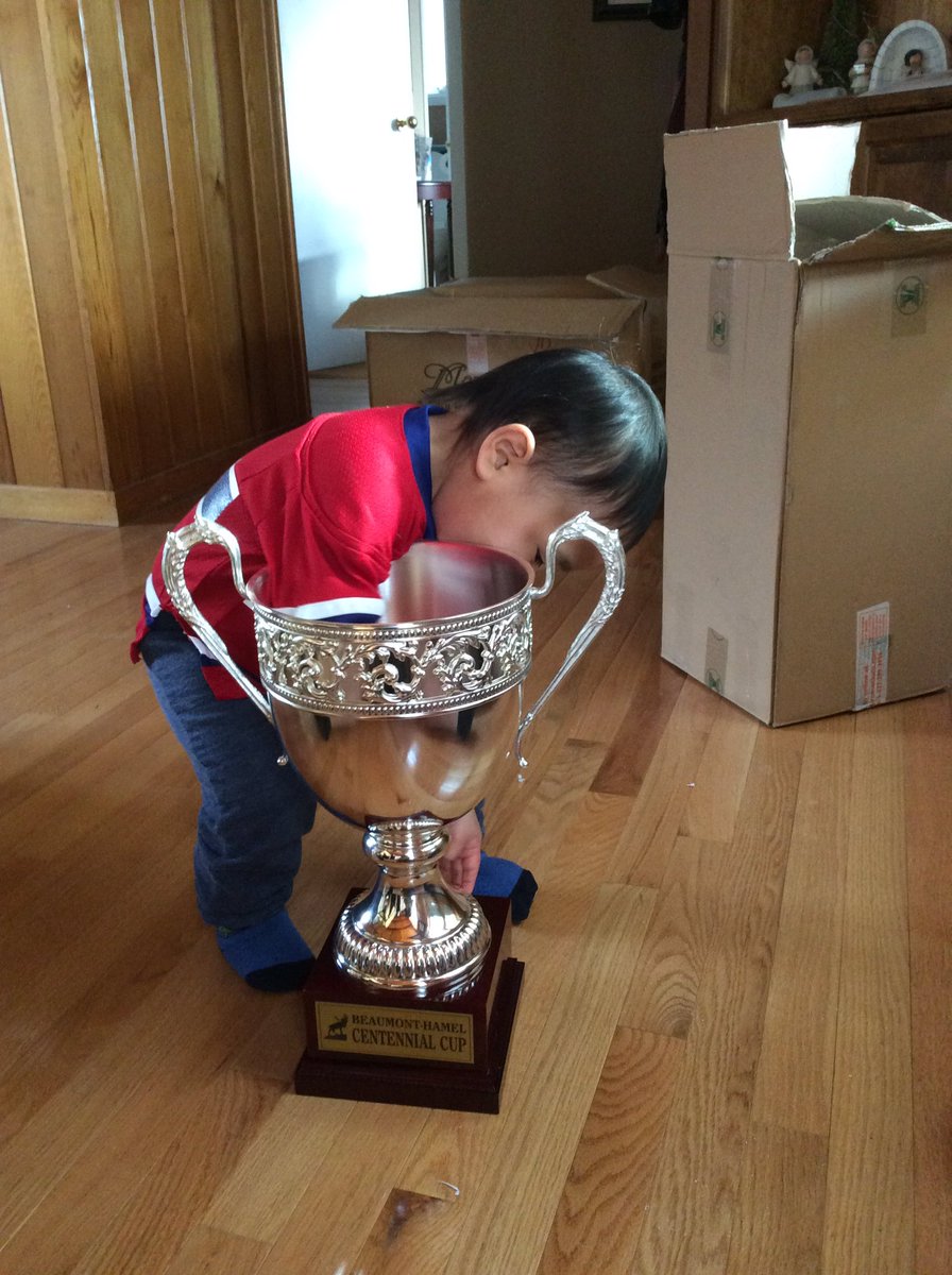 HSFalconHockey's tweet photo. Future competitor checking out the hard wear. Still has a couple of years before he gets the chance to rise the cup https://t.co/83glTSSC08
