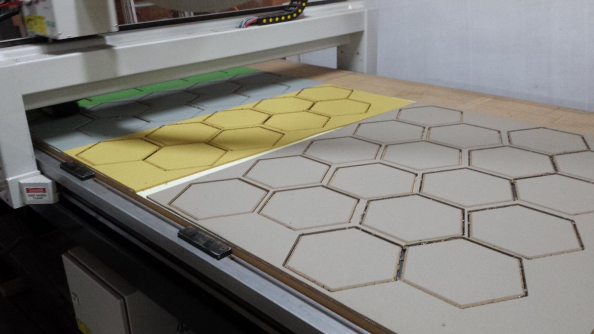 CNC machine busy cutting Mini Hexagon Pinboards in 4 colours for an office in Sydney CBD.  #pinboardenvy