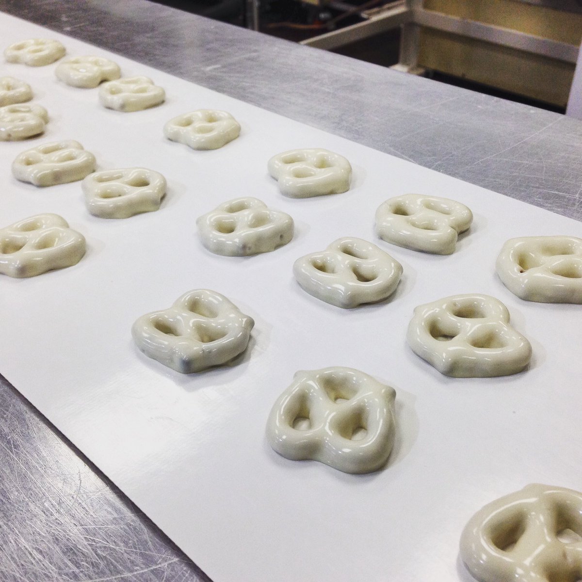 WinansChocolate's tweet photo. We're running #whitechocolate this week! On the #enrober now: white chocolate mini wetzels! #winanschocolate https://t.co/0Uw4dJHgDz