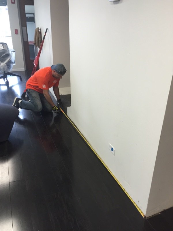The associates from store 1913 giving back by installing base moulding in a veteran's home.