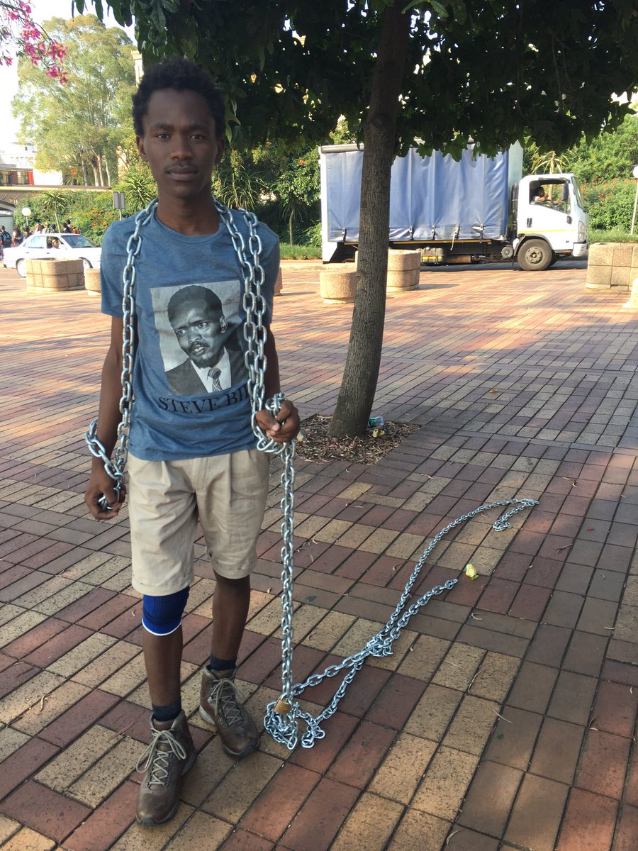 #Wits student, Mandla Mbuyisa, wraps himself in chains to symbolize the struggles of black students <a href="/eNCA/">eNCA</a>