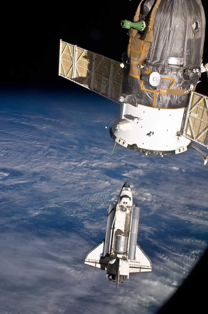 SpaceShuttleDiscovery and the ISS during their rendezvous.Part of Russian spacecraft on the foreground #apr2010