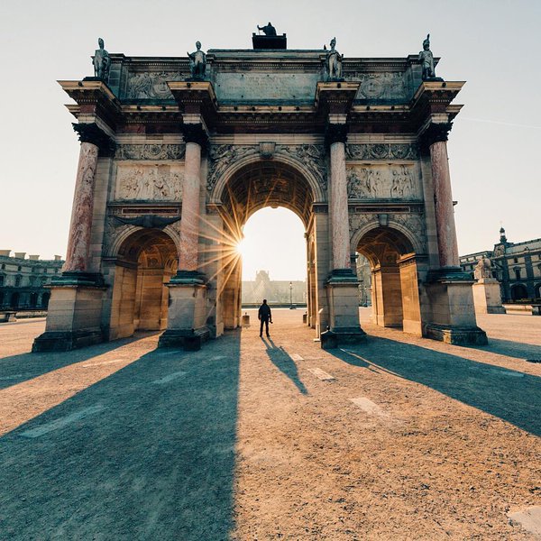 Morning light through the Arc de Triomphe du Carrousel, with the Louvre in the background.