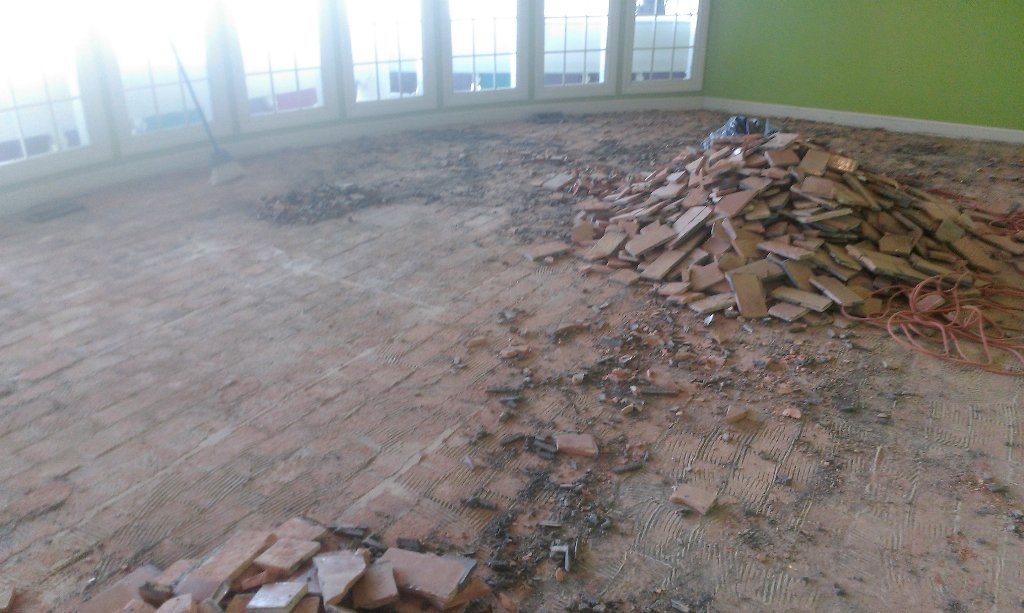 Demoing the sunroom bricks to make way for hardwood flooring 😊