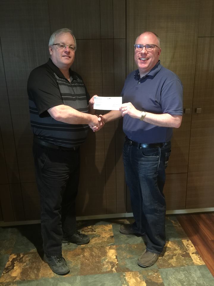 ABA board member Bob Bailey presents a $900 cheque to ABA President Darwin Krips in support of the fundraiser