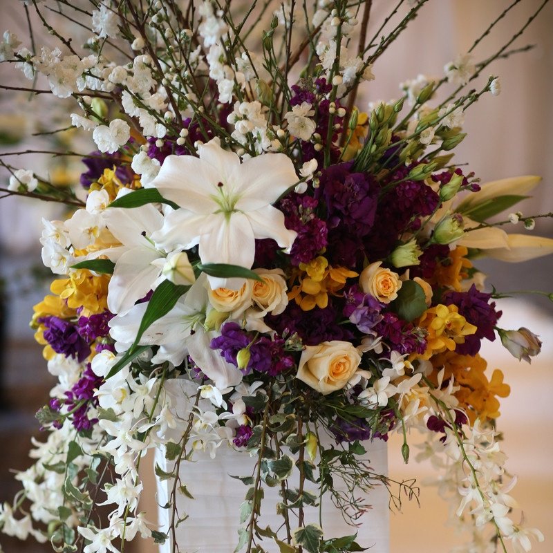 An arrangement of white, purple, and yellow flowers is beautifully exquisite. #FlowerFriday