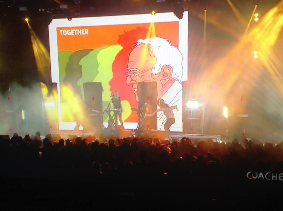 TheBernReport's tweet photo. .@coachella just turned into a massive @BernieSanders rally when @Grimezsz put this banner on stage. #NotAMeeting https://t.co/r0M5SnuXTW