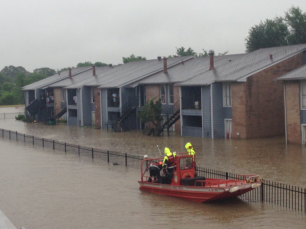 Firefighters on boat rescuing trapped apartment residents on Greens Road. #KHOUweather