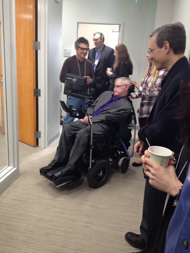 PeterDEdmonds's tweet photo. Stephen Hawking at the Black Hole Initiative workshop, with Avi Loeb in foreground, Tony Beasley in back.#BHinit https://t.co/LzXO669kI8