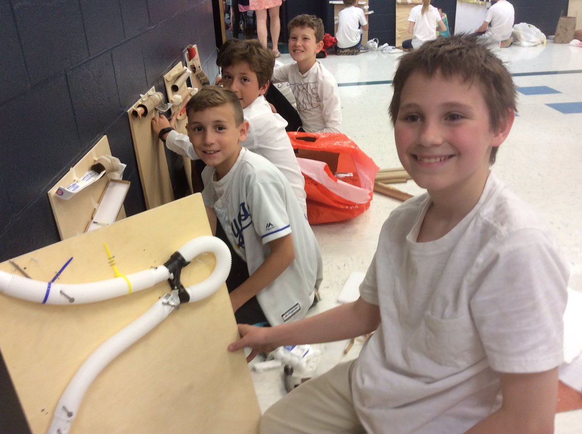 Fifth graders building marble mazes.