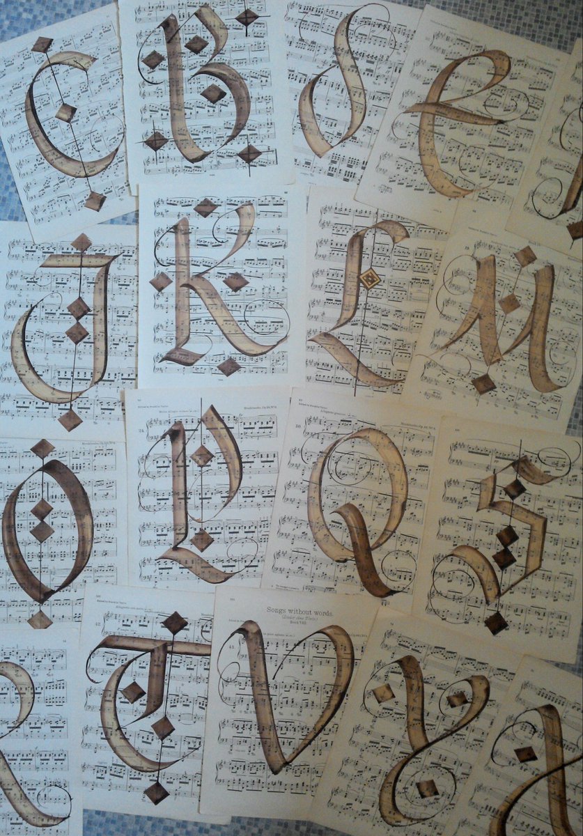BrianTheScriber's tweet image. Huge letters scribed upon vintage music paper with a #automaticpen Mingling sepia and gold inks
