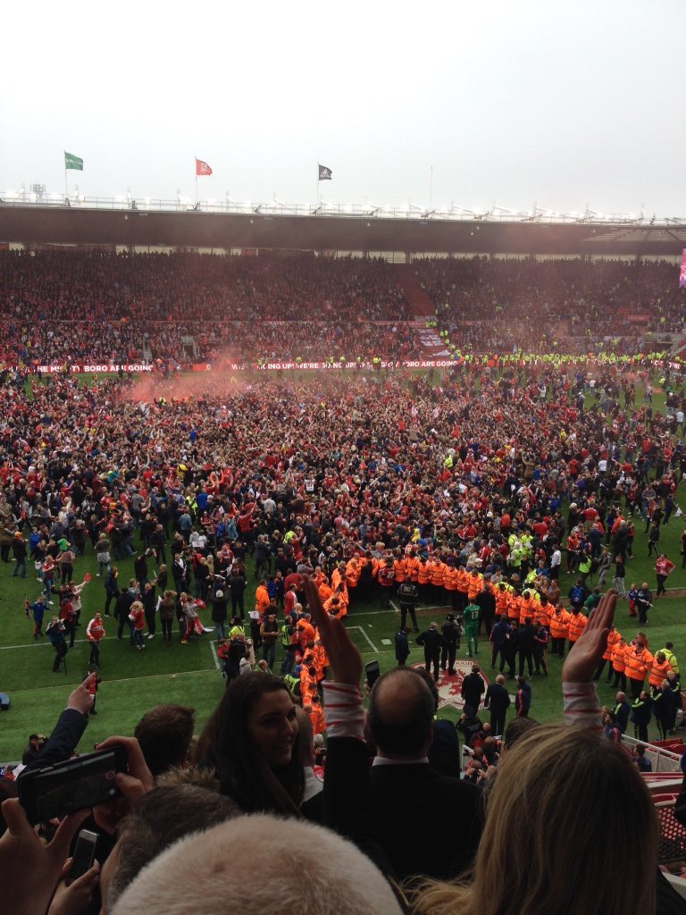AwayDays_'s tweet photo. Middlesbrough pitch invasion after securing promotion to the Premier League today. #boro https://t.co/J49eaAX2Ue
