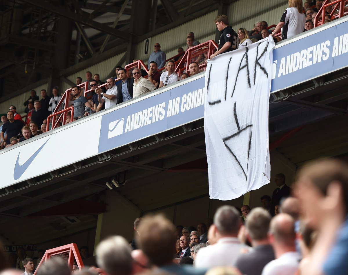 Charlton fans produce a 'Liar' banner with an arrow pointing down at the club's chief executive