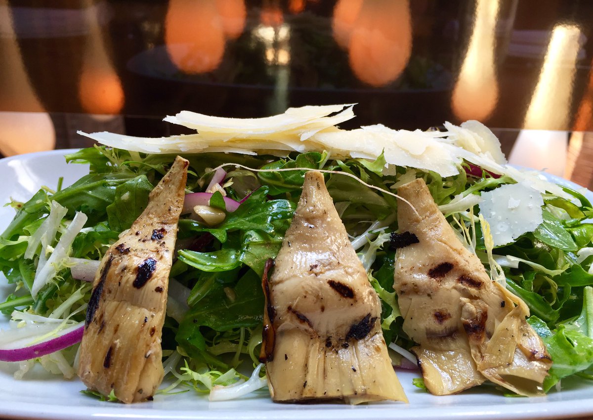 Insalata Carciofo- grilled baby artichokes, arugula, frisée, red onion &amp; lemon dressing with shaved Parmesan.