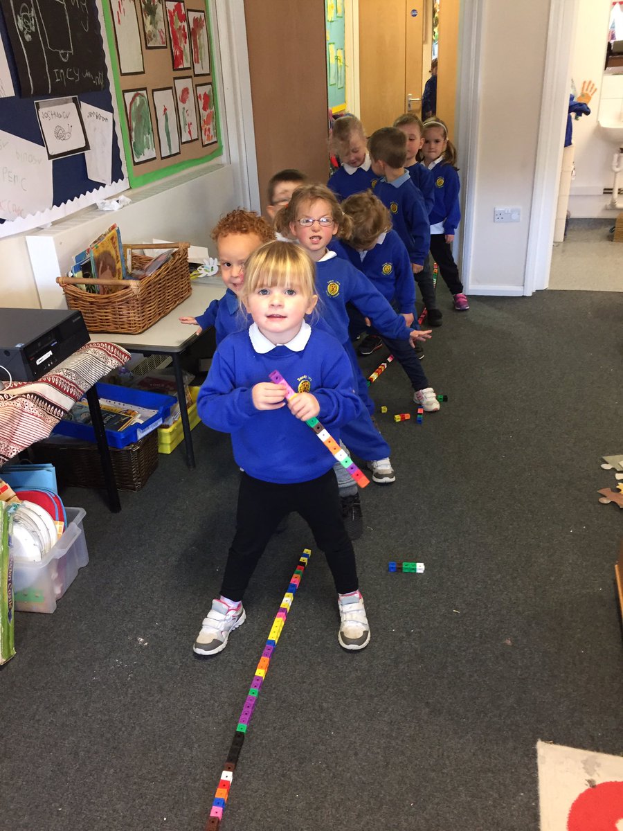 Fantastic team work in Nursery this morning ~ linking cubes from the door to the window ~ great perseverance by all