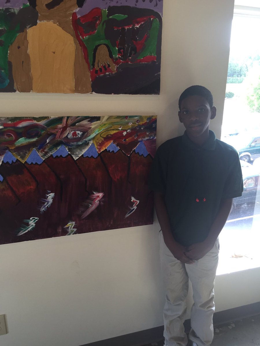 SocialHandUp's tweet photo. Taquan next to his artwork which he describes as "how the future is going to look." Good job kid. #thesocialhandup https://t.co/2L1rHQtv9P
