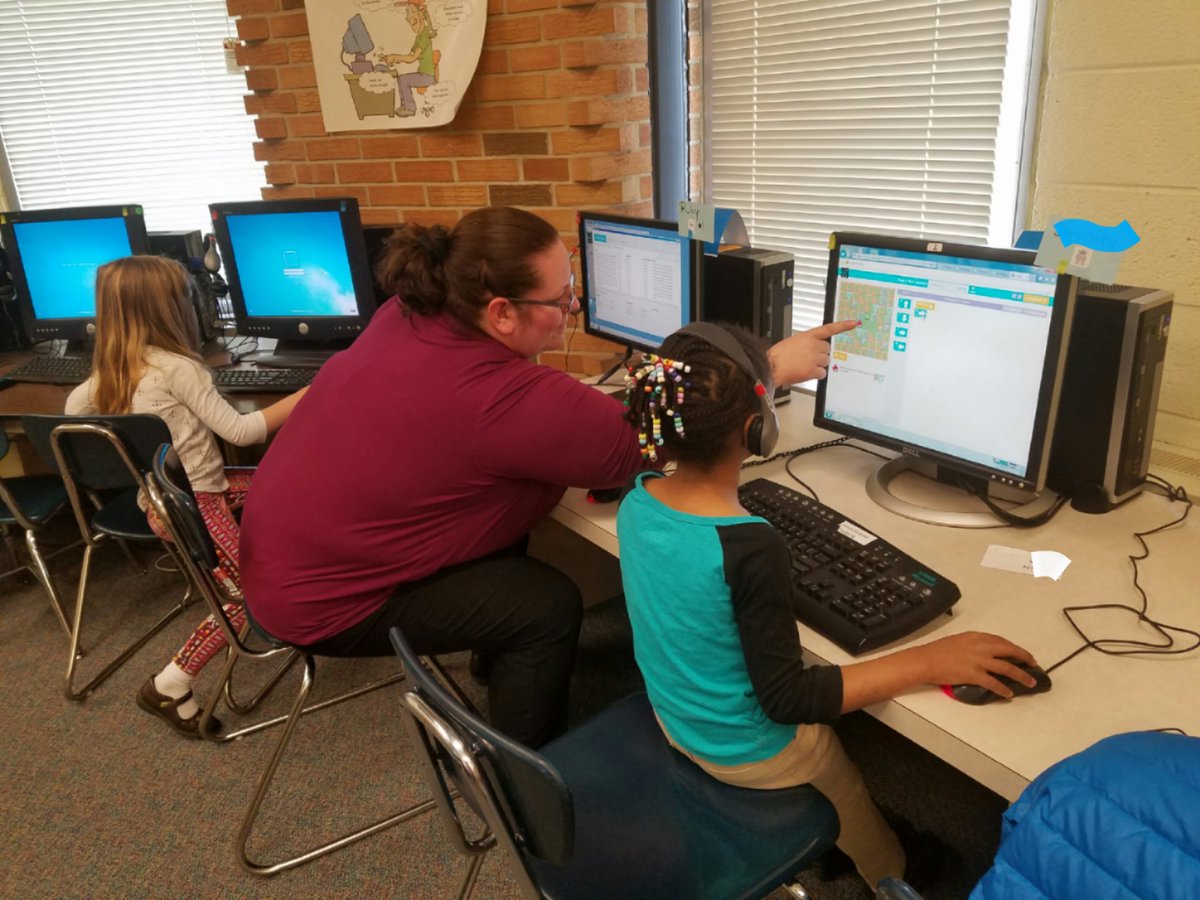 Mitchellcoder's tweet photo. Our computer analyst fixing a computer takes a moment to help a kindergarten student with code. https://t.co/w6iJDIz4p3