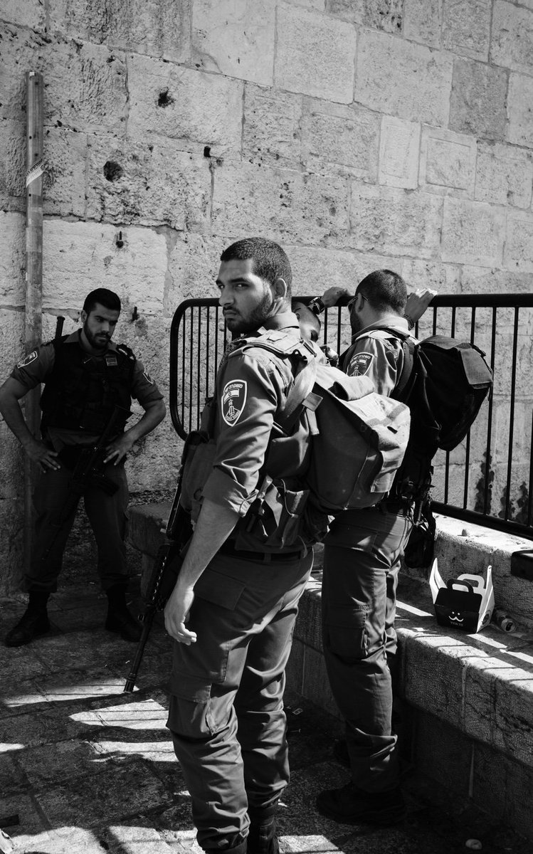 BowenBBC's tweet photo. Israeli border policeman engages with the camera as they search a Palestinian man at Damascus Gate in #Jerusalem https://t.co/HEIdMVFV5g