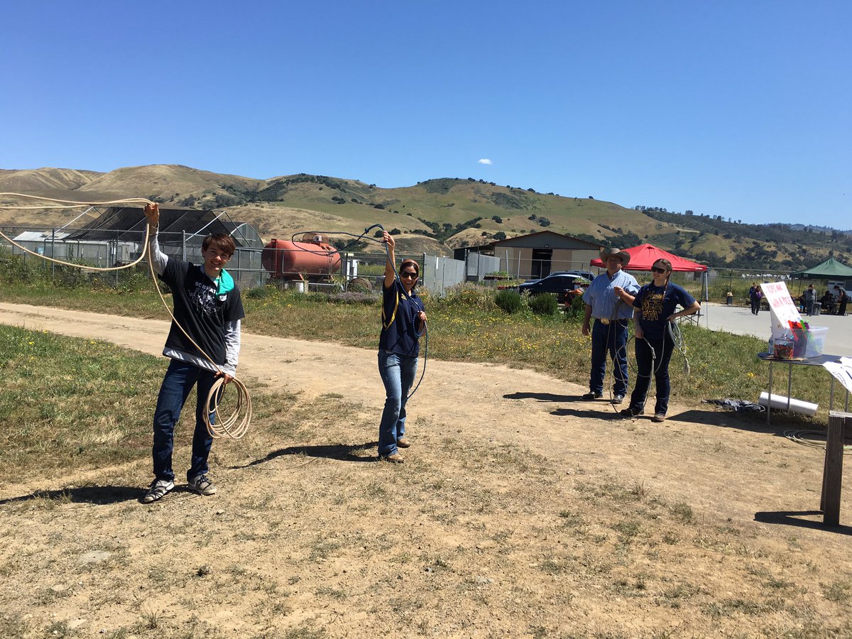 Advisors and officers having fun and learning how to rope at Farm Fun Day.