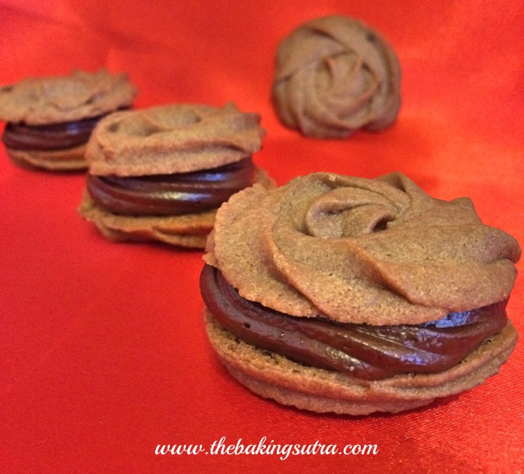 thebakingsutra's tweet photo. Chocolate rosettes cookies with cinnamon infused Belgian dark chocolate ganache https://t.co/dujEjcii5s https://t.co/f5qsvFg346