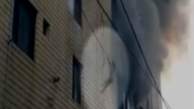 CNN's tweet image. 'You're alive!': Mother, 3 children fall from burning building in incredible escape cnn.it/1Z7Rw6y