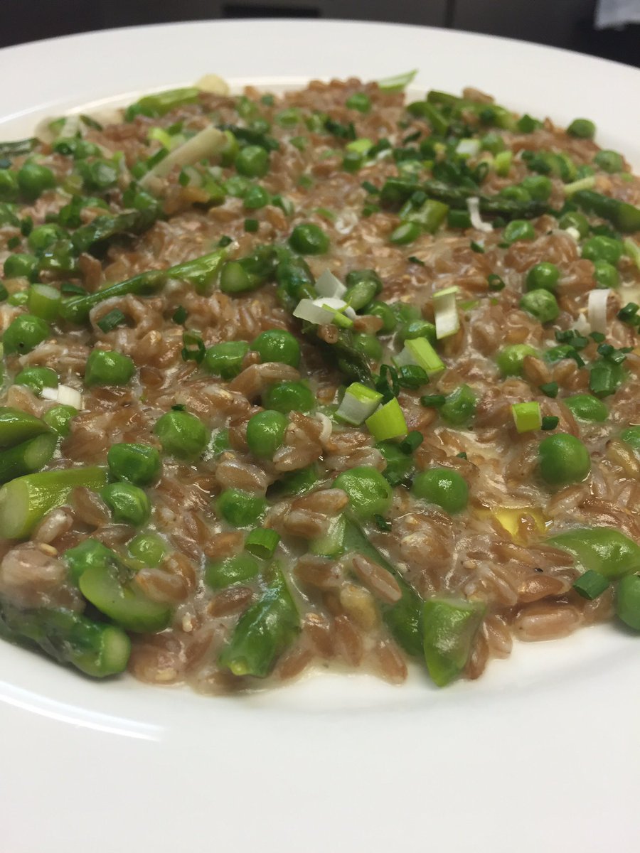 Farroto- faro is prepared risotto style with asparagus, spring peas &amp; scallions finished with Parmigiano Reggiano.