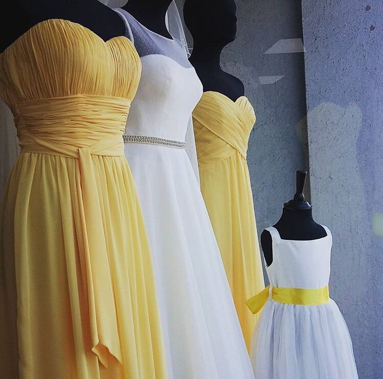 Our window this week is all about trying to entice the sun to stay out. #sunshine #yellow #windowdisplay