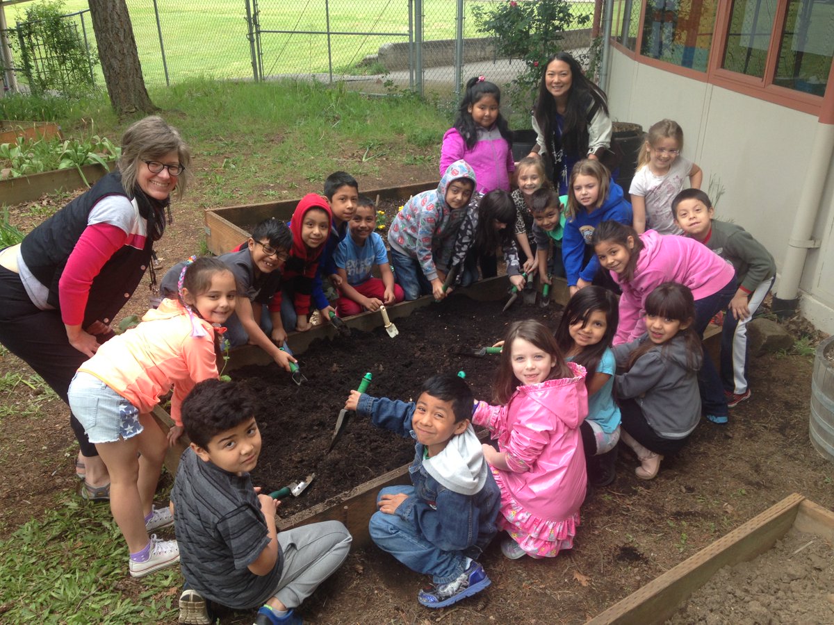 Ms. Honda's 1st graders out gardening! Happy students!