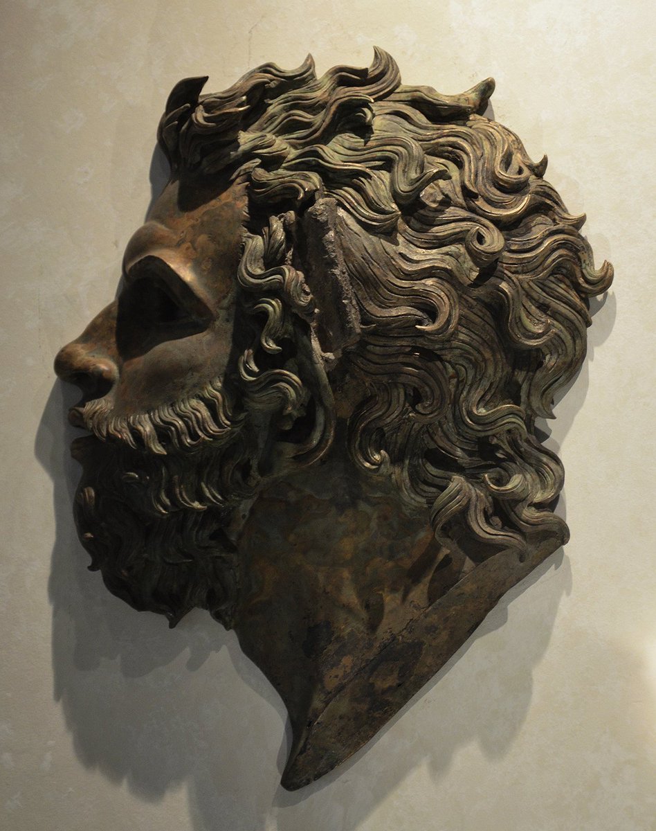 carolemadge's tweet photo. Bronze applique of a male head representing a divinity, probably a wind, found in the Aquileia Forum, mid-1st c. BC. https://t.co/cktTsJPLCv
