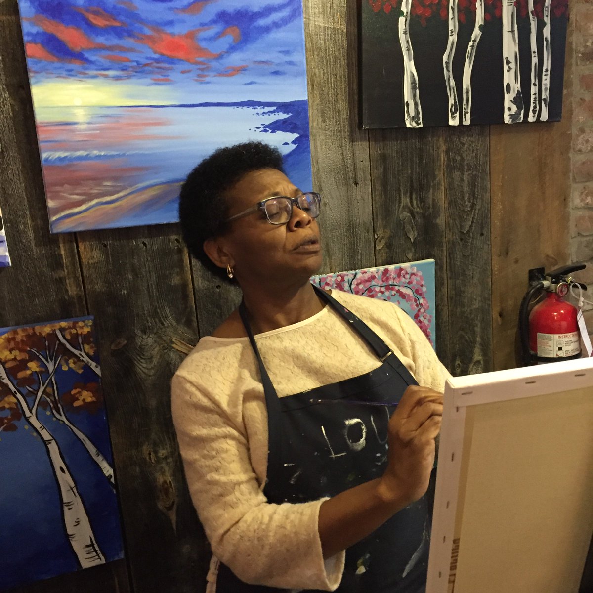 NAPSW's tweet photo. Joan is studying her masterpiece! Enjoying the paint night! #NAPSW #NAPSW2016 https://t.co/hheCMWnspb