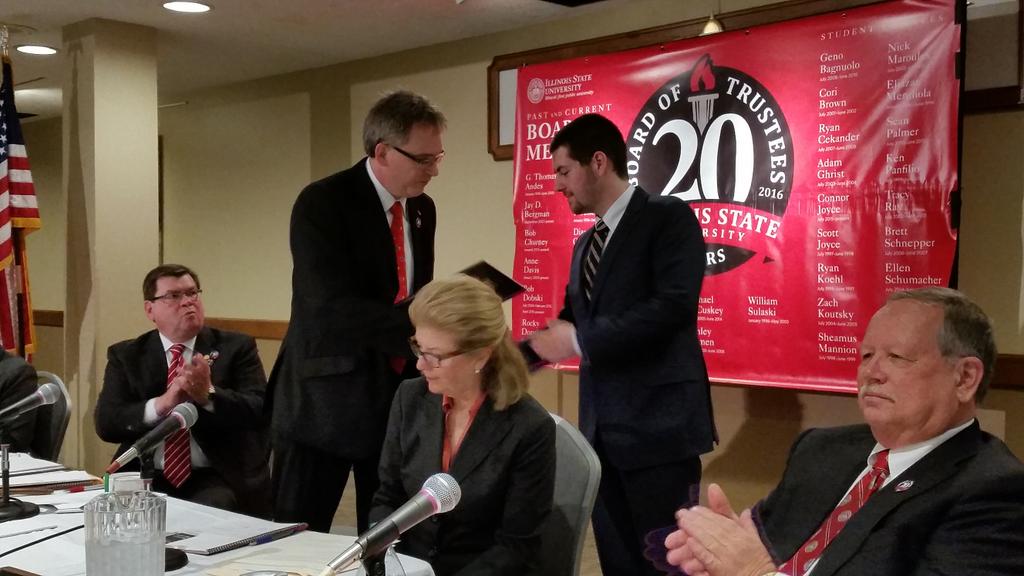 Board chair Rocky Donahue congratulates outgoing student trustee Connor Joyce <a href="/IllinoisStateU/">Illinois State</a> .