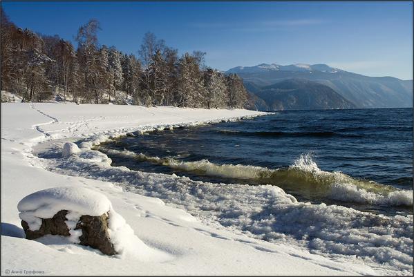 Snow covered beach on the shores of Lake Teletskoye, Altai Republic, Russia