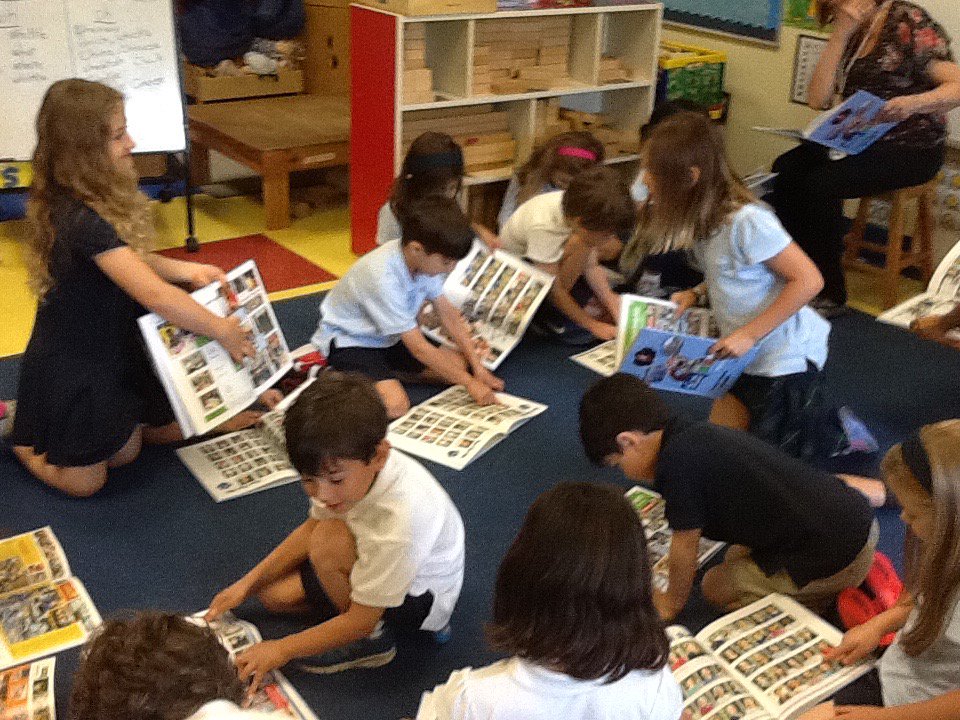 KinderKaboodle's tweet photo. Looking at yearbooks for the first time!  What excitement!  #trinitylearns https://t.co/8xjFEgzYbk