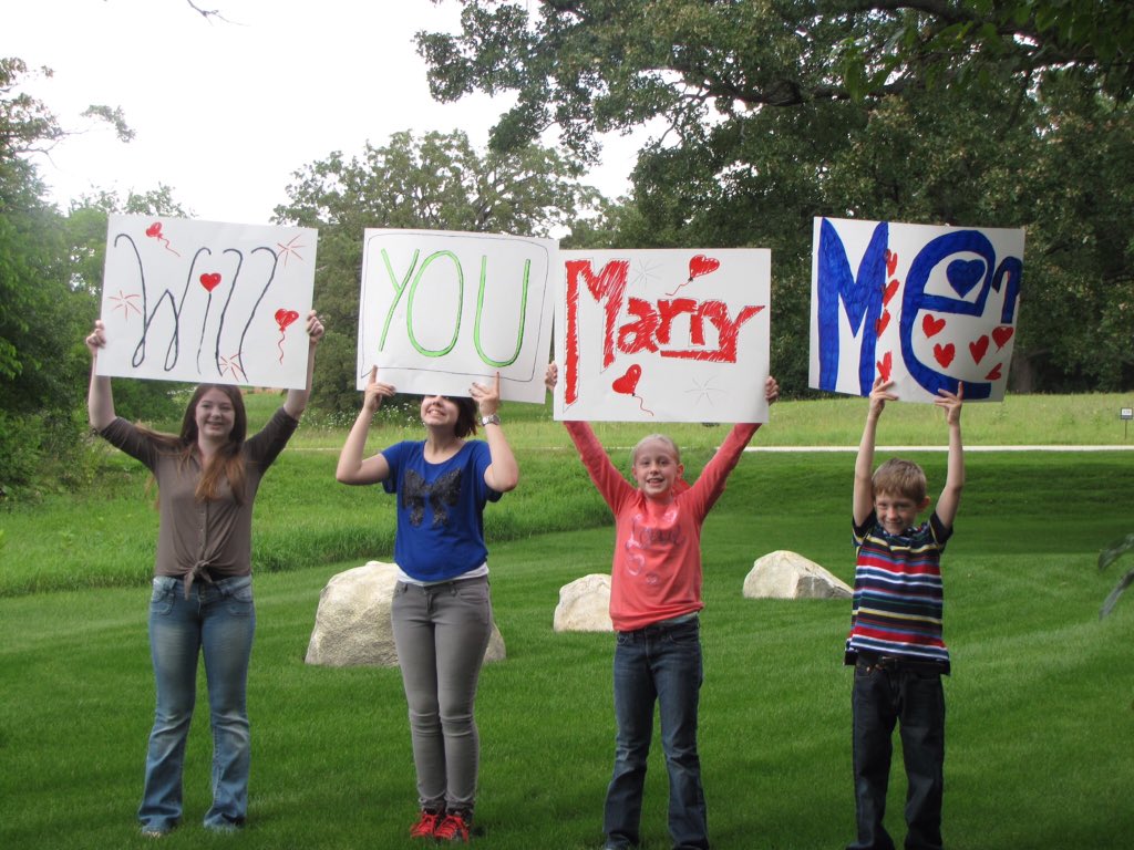 Smark7379's tweet photo. @FrameableFaces #FrameGameLove @PlayForStuffTV How my fiancé asked me to marry him. Our kids made their own sign. https://t.co/wGuW8czcVx
